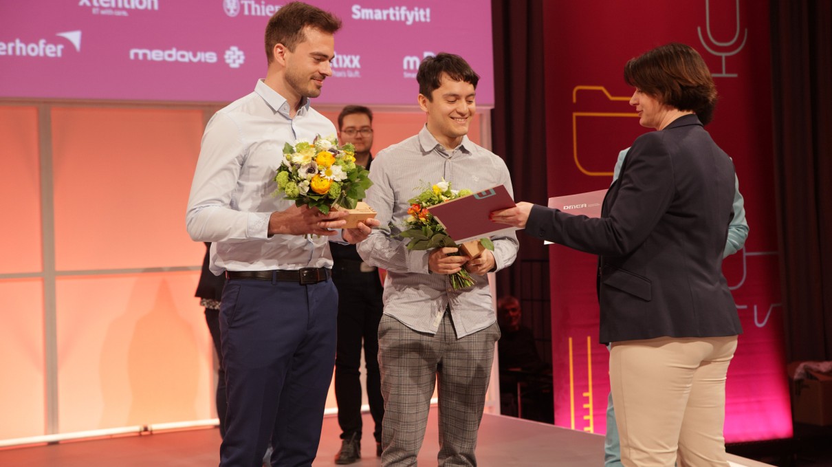 Presentation of the DMEA Young Talent Award to Lars Anderegg and Jonas Jiménez by bvitg Managing Director Melanie Wendling