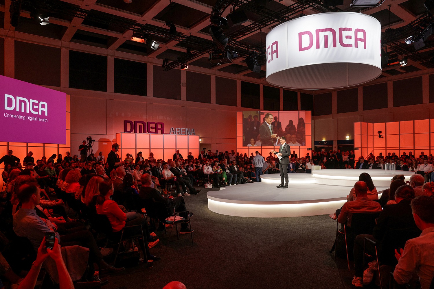 Federal Minister of Health Prof Dr Karl Lauterbach stands on the stage at DMEA 2024 - surrounded by the audience. Federal Minister of Health Prof Dr Karl Lauterbach stands on the stage at DMEA 2024 - surrounded by the audience.